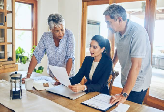 a lawyer discussing some documents to the old couple