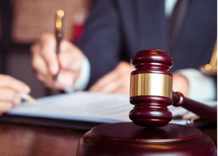 an image of an attorney signing a document